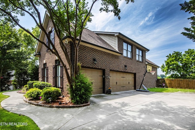 8507 Cloudbreak Ln Unit 4, Knoxville, TN 37938 - view of side of home with an attached garage, brick siding, and concrete driveway