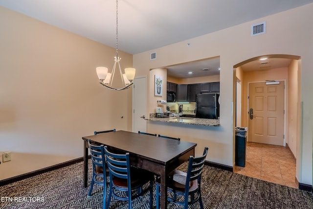 225 Collier Dr Unit 2212, Sevierville, TN 37862 - dining space featuring arched walkways, a chandelier, and light tile patterned floors