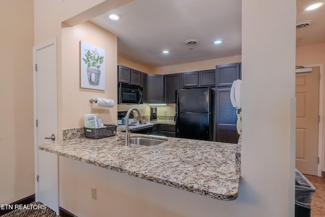 225 Collier Dr Unit 2212, Sevierville, TN 37862 - kitchen featuring black appliances, light stone counters, recessed lighting, and a peninsula