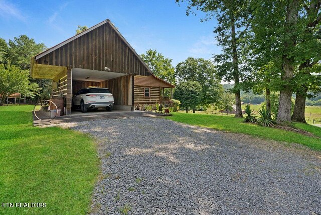1821 S Nopone Valley Rd, Decatur, TN 37322 - view of side of property with driveway, a lawn, and board and batten siding