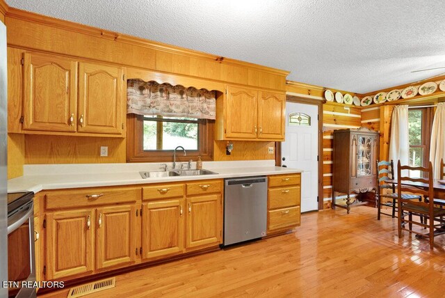 1821 S Nopone Valley Rd, Decatur, TN 37322 - kitchen with stainless steel appliances, a textured ceiling, light countertops, light wood-type flooring, and crown molding