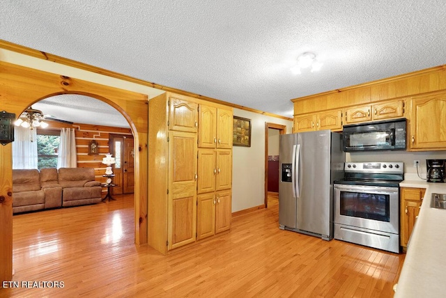 1821 S Nopone Valley Rd, Decatur, TN 37322 - kitchen with stainless steel appliances, ornamental molding, light wood-style floors, a textured ceiling, and light countertops