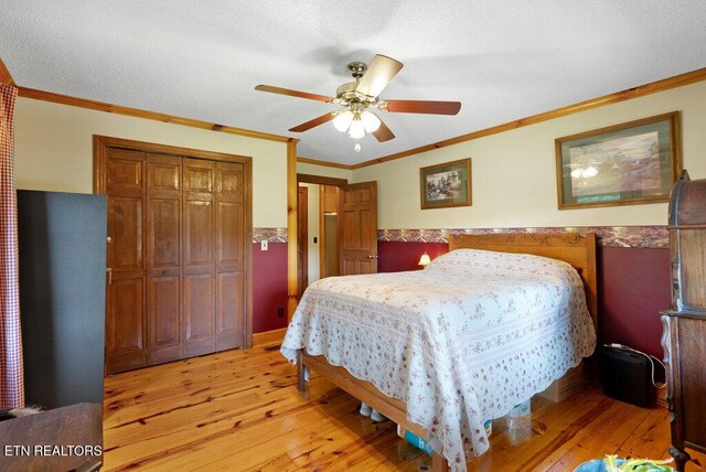 1821 S Nopone Valley Rd, Decatur, TN 37322 - bedroom with light wood finished floors, a closet, crown molding, and a ceiling fan