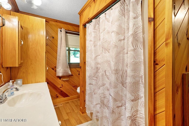 1821 S Nopone Valley Rd, Decatur, TN 37322 - full bathroom featuring wood finished floors, wood walls, ornamental molding, vanity, and a shower with shower curtain