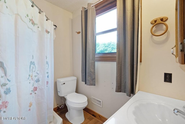 1821 S Nopone Valley Rd, Decatur, TN 37322 - full bathroom with wood finished floors, a shower with shower curtain, and a textured ceiling