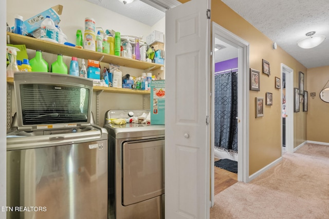 1717 Meadow Ridge Cir, Sevierville, TN 37862 - laundry room featuring washing machine and clothes dryer, light carpet, and a textured ceiling