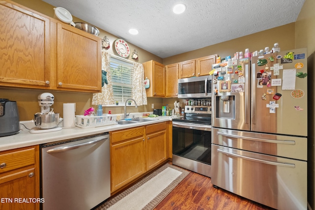 1717 Meadow Ridge Cir, Sevierville, TN 37862 - kitchen with appliances with stainless steel finishes, a textured ceiling, light countertops, and wood finished floors