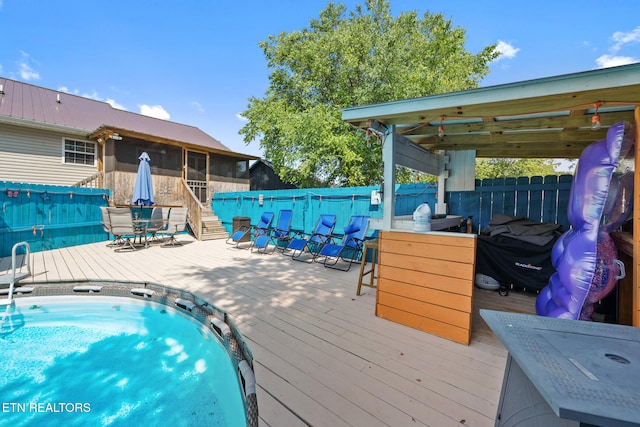 1717 Meadow Ridge Cir, Sevierville, TN 37862 - view of swimming pool featuring a wooden deck, a sunroom, and outdoor dining area