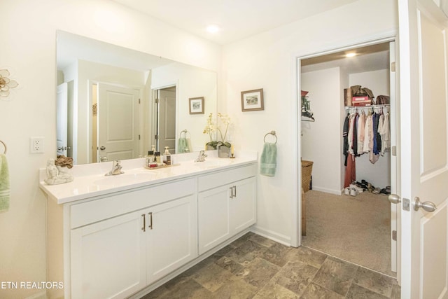 7408 Game Bird St, Corryton, TN 37721 - full bathroom with double vanity, a walk in closet, and stone finish flooring
