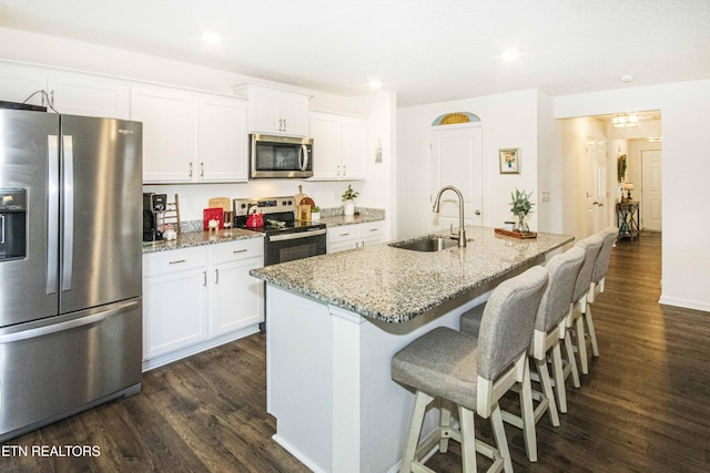 7408 Game Bird St, Corryton, TN 37721 - kitchen featuring appliances with stainless steel finishes, dark wood-style flooring, white cabinets, light stone counters, and recessed lighting