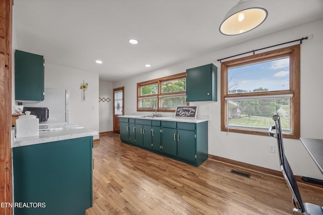 2931 E Emory Rd, Knoxville, TN 37938 - kitchen featuring light countertops, light wood finished floors, green cabinets, and recessed lighting