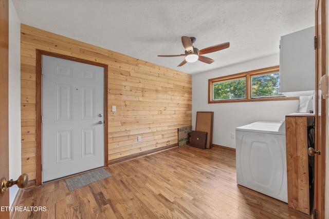 2931 E Emory Rd, Knoxville, TN 37938 - washroom with wooden walls, a ceiling fan, washer / dryer, wood finished floors, and a textured ceiling