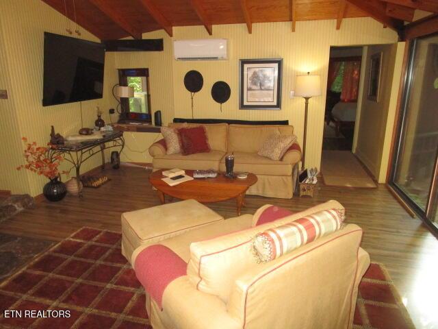 262 Mountain View Dr, Rutledge, TN 37861 - living area featuring a wall unit AC, wood finished floors, and wooden ceiling