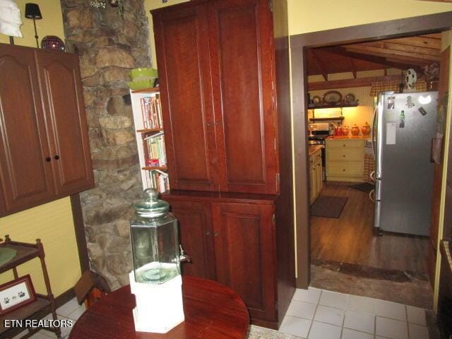 262 Mountain View Dr, Rutledge, TN 37861 - kitchen with freestanding refrigerator, beamed ceiling, and light tile patterned floors