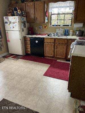 11336 Wrens Nest Ln, Knoxville, TN 37932 - kitchen with dishwasher, freestanding refrigerator, and light countertops