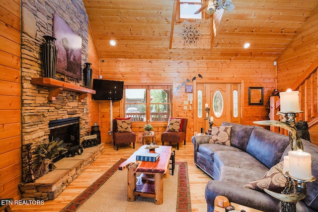 2028 Piney Overlook Ln, Sevierville, TN 37862 - living area with a ceiling fan, hardwood / wood-style floors, wooden ceiling, wood walls, and a stone fireplace