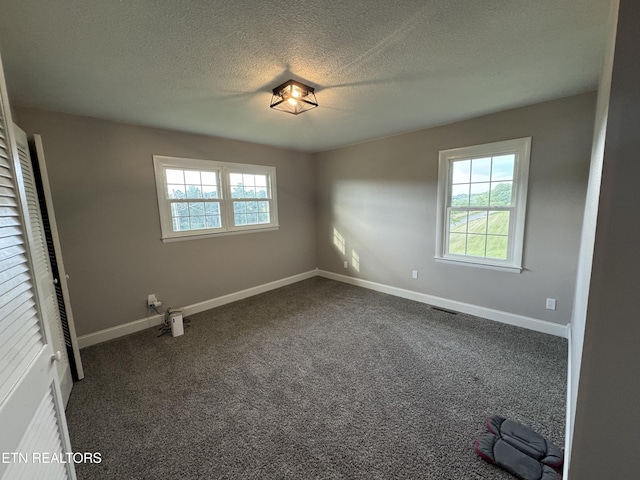115 Red Oak Ln, New Tazewell, TN 37825 - unfurnished room featuring a textured ceiling and dark colored carpet