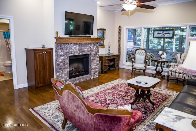 520 Wimberly Rd, Crossville, TN 38558 - living room with a ceiling fan, ornamental molding, dark wood-style flooring, and a brick fireplace
