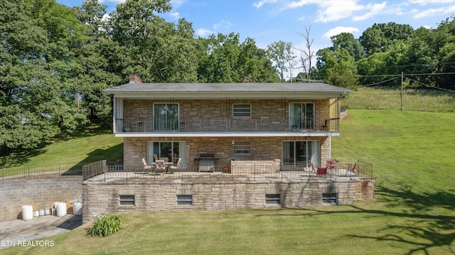 1175 Cardnal Cv, Rutledge, TN 37861 - view of front of house with stone siding, a front lawn, a chimney, and a balcony