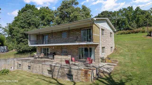 1175 Cardnal Cv, Rutledge, TN 37861 - back of house featuring stone siding, a balcony, a patio area, and a yard