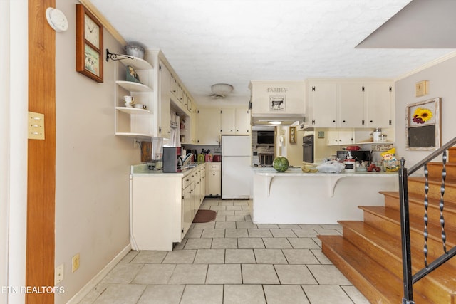 1175 Cardnal Cv, Rutledge, TN 37861 - kitchen with freestanding refrigerator, a peninsula, oven, light countertops, and a textured ceiling