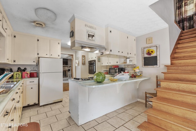 1175 Cardnal Cv, Rutledge, TN 37861 - kitchen with black appliances, light tile patterned floors, a peninsula, crown molding, and light countertops