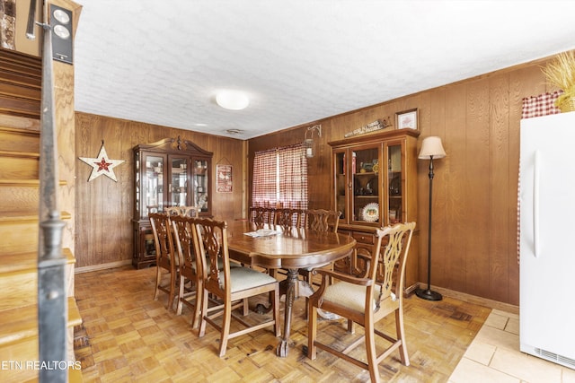 1175 Cardnal Cv, Rutledge, TN 37861 - dining room featuring wood walls, stairs, and a textured ceiling