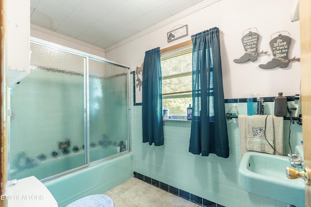 1175 Cardnal Cv, Rutledge, TN 37861 - bathroom featuring ornamental molding, combined bath / shower with glass door, tile walls, a wainscoted wall, and tile patterned floors