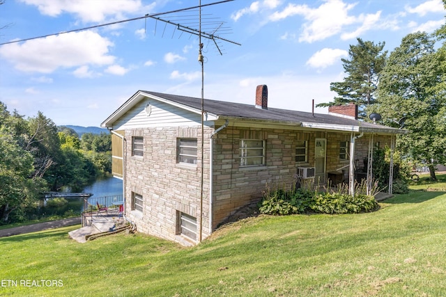 1175 Cardnal Cv, Rutledge, TN 37861 - view of home's exterior with stone siding, a chimney, and a yard