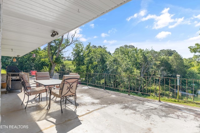 1175 Cardnal Cv, Rutledge, TN 37861 - view of patio featuring outdoor dining area, grilling area, and view of scattered trees