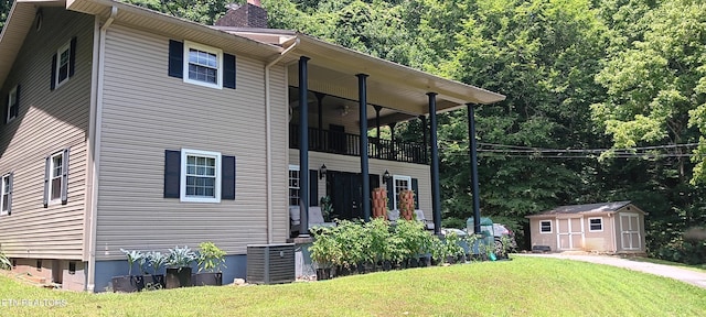 5412 E Lamar Alex Pkwy, Walland, TN 37886 - view of home's exterior with a chimney, a storage shed, a lawn, and a balcony