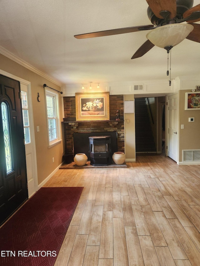 5412 E Lamar Alex Pkwy, Walland, TN 37886 - foyer entrance with a ceiling fan, light wood finished floors, ornamental molding, a wood stove, and stairway