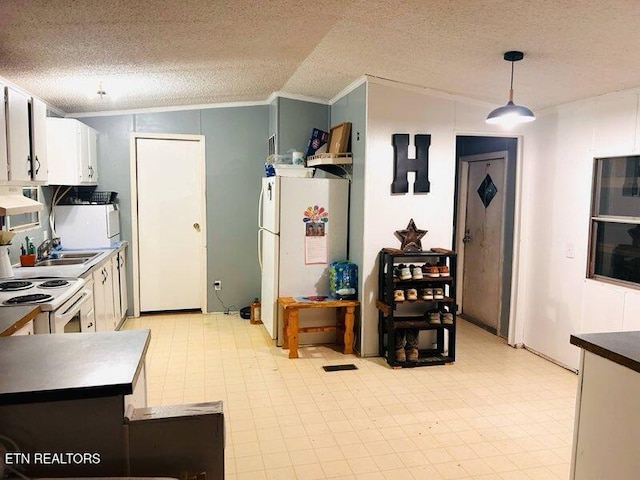 181 Claude Hargis Ln, Crawford, TN 38554 - kitchen with crown molding, white appliances, a textured ceiling, lofted ceiling, and light flooring