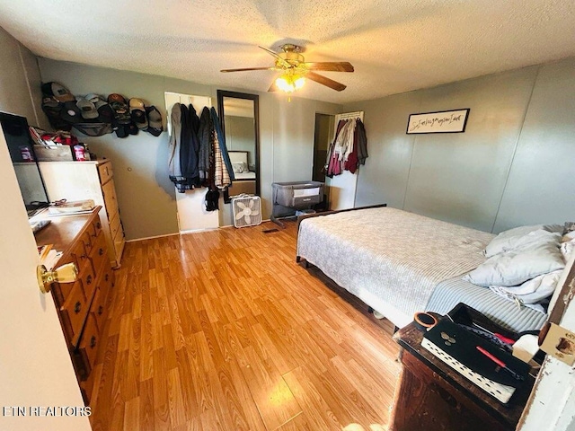 181 Claude Hargis Ln, Crawford, TN 38554 - bedroom with light wood finished floors, a textured ceiling, and ceiling fan