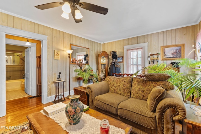 313 Locust St, Englewood, TN 37329 - living room with ornamental molding, wooden walls, ceiling fan, and wood finished floors