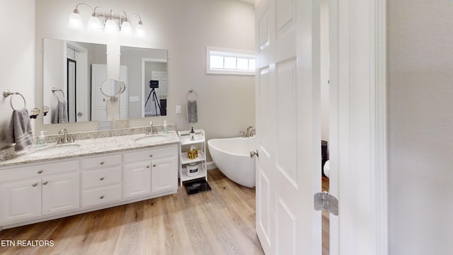 101 Maca Ridge Cir, Clarkrange, TN 38553 - full bathroom with double vanity, a freestanding bath, and wood finished floors