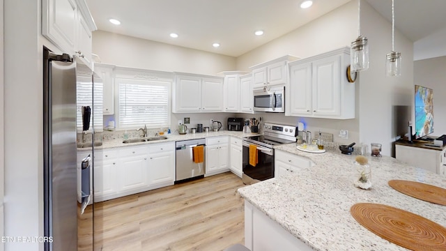 101 Maca Ridge Cir, Clarkrange, TN 38553 - kitchen featuring stainless steel appliances, light wood-style floors, white cabinetry, light stone countertops, and recessed lighting