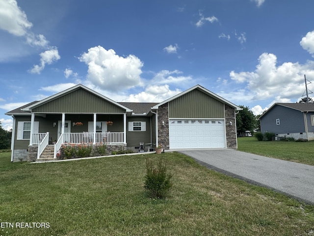 101 Maca Ridge Cir, Clarkrange, TN 38553 - view of front facade featuring driveway, covered porch, an attached garage, a front lawn, and stone siding