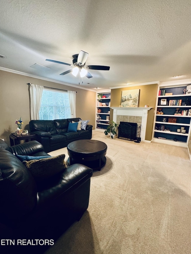 13001 Sanderling Ln, Knoxville, TN 37922 - carpeted living area featuring a textured ceiling, crown molding, ceiling fan, a tile fireplace, and built in features