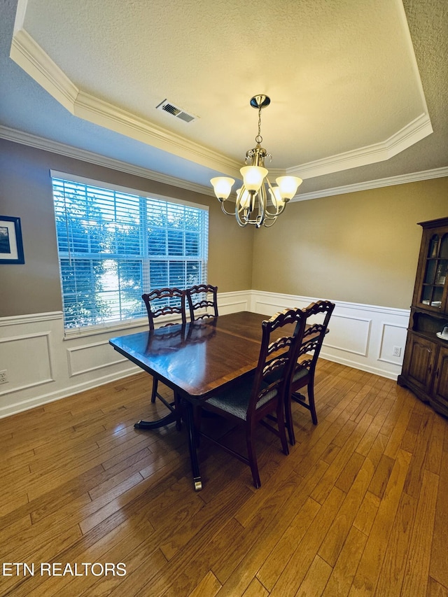 13001 Sanderling Ln, Knoxville, TN 37922 - dining room with a tray ceiling, a chandelier, wood-type flooring, crown molding, and a wainscoted wall