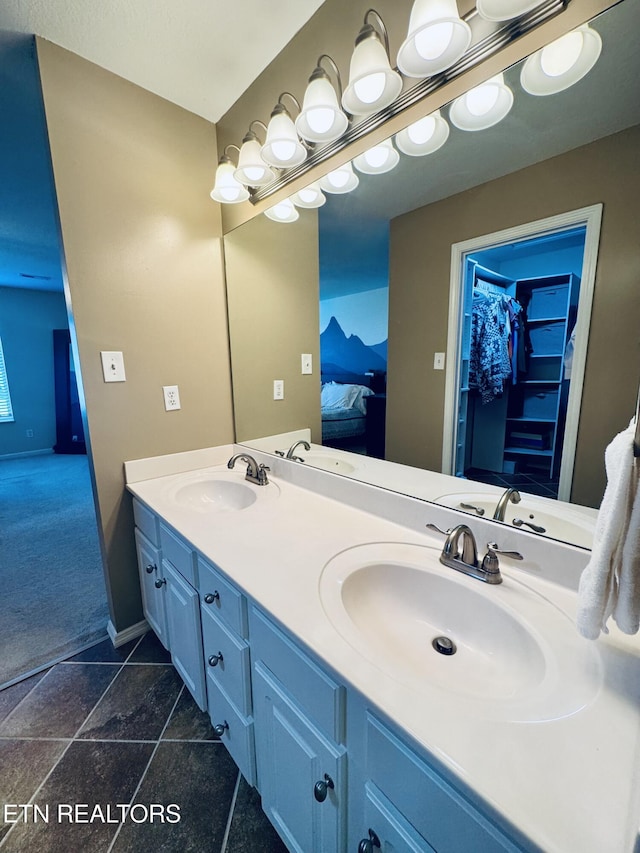 13001 Sanderling Ln, Knoxville, TN 37922 - ensuite bathroom featuring double vanity, a walk in closet, and stone tile floors