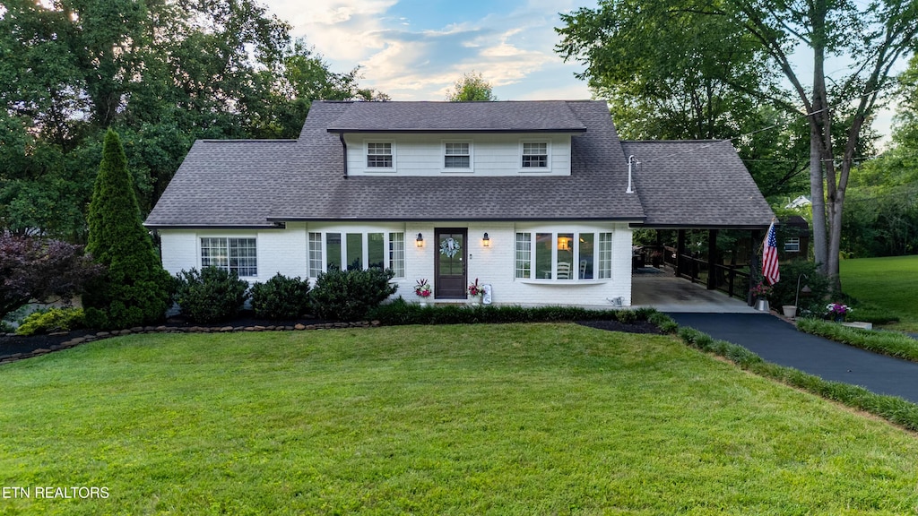 113 Cumberland View Dr, Oak Ridge, TN 37830 - view of front of property featuring asphalt driveway, a front lawn, an attached carport, a shingled roof, and brick siding