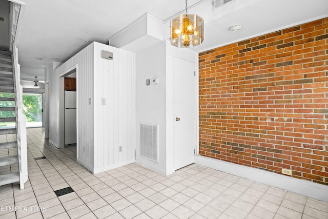 2806 Suncrest Rd Apt 4, Pigeon Forge, TN 37863 - spare room featuring brick wall, a chandelier, a smoke detector, and stairway
