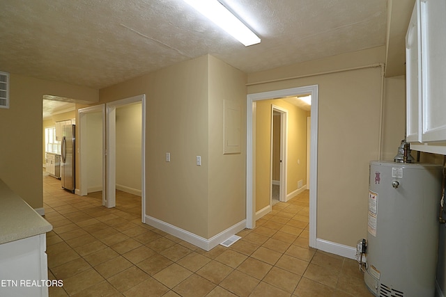 22453 Alberta St, Oneida, TN 37841 - hallway with gas water heater, light tile patterned floors, electric panel, and a textured ceiling