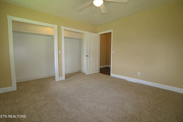22453 Alberta St, Oneida, TN 37841 - unfurnished bedroom featuring multiple closets, carpet, and a ceiling fan