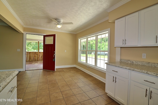 22453 Alberta St, Oneida, TN 37841 - kitchen featuring a ceiling fan, light tile patterned floors, white cabinets, ornamental molding, and a textured ceiling