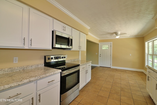 22453 Alberta St, Oneida, TN 37841 - kitchen with stainless steel appliances, light tile patterned flooring, ornamental molding, ceiling fan, and white cabinets