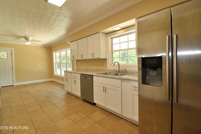 22453 Alberta St, Oneida, TN 37841 - kitchen with appliances with stainless steel finishes, light tile patterned flooring, a textured ceiling, crown molding, and white cabinetry