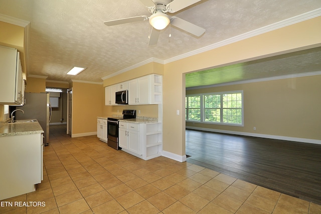 22453 Alberta St, Oneida, TN 37841 - kitchen with appliances with stainless steel finishes, open shelves, light tile patterned flooring, white cabinetry, and open floor plan