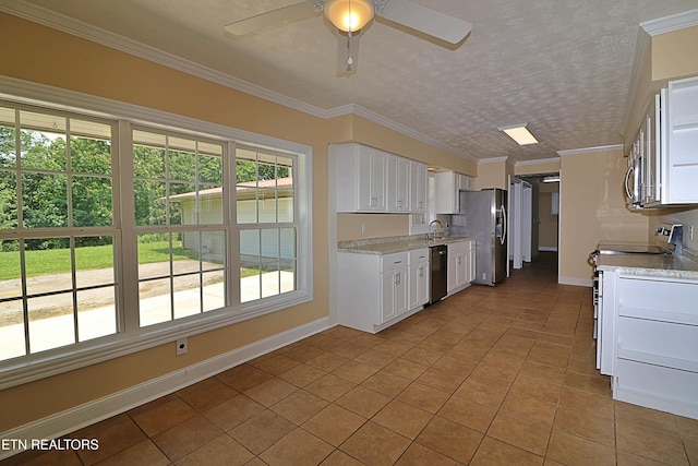 22453 Alberta St, Oneida, TN 37841 - kitchen featuring stainless steel appliances, light tile patterned floors, ceiling fan, white cabinetry, and crown molding